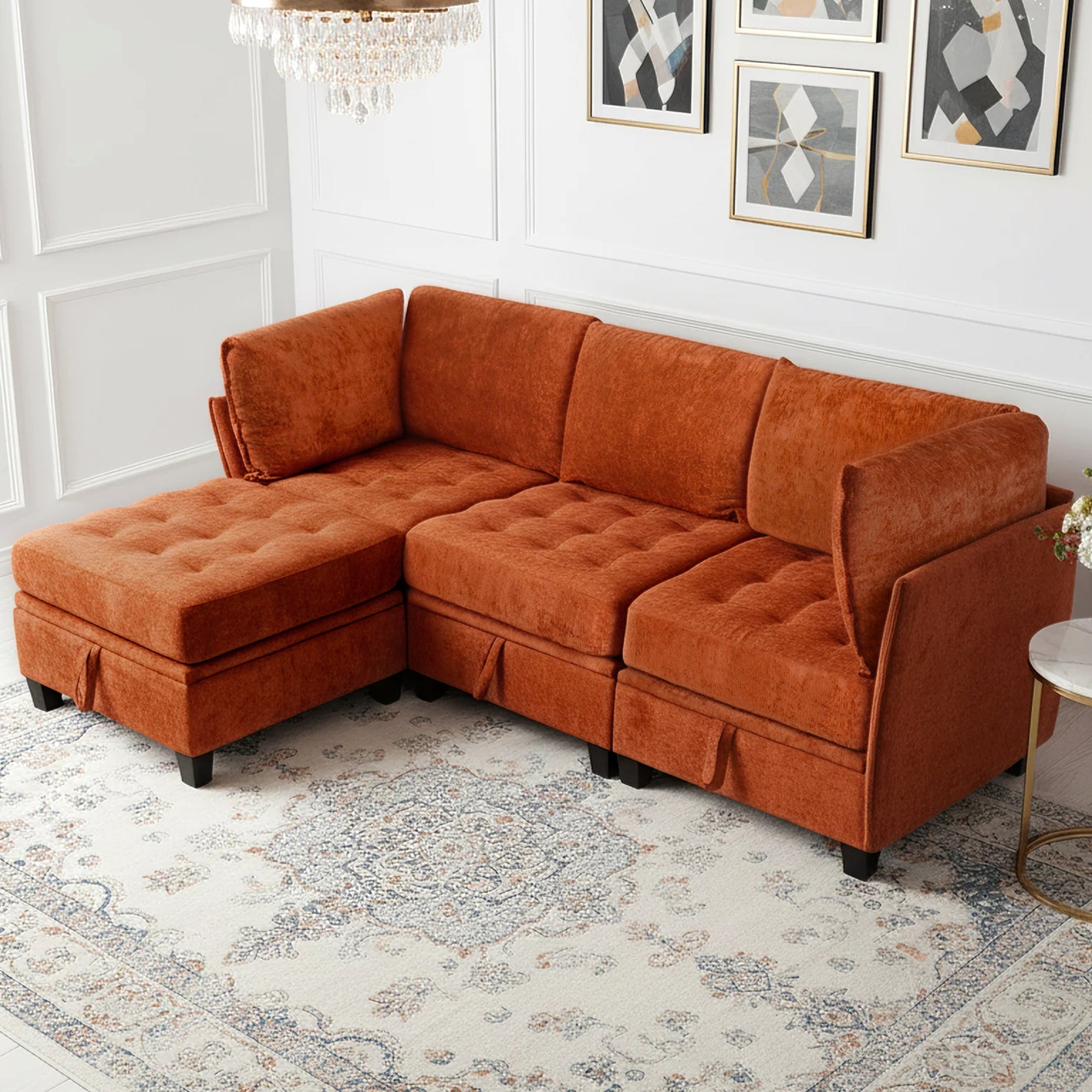 Orange sectional sofa in a living room setting with framed art on the wall.