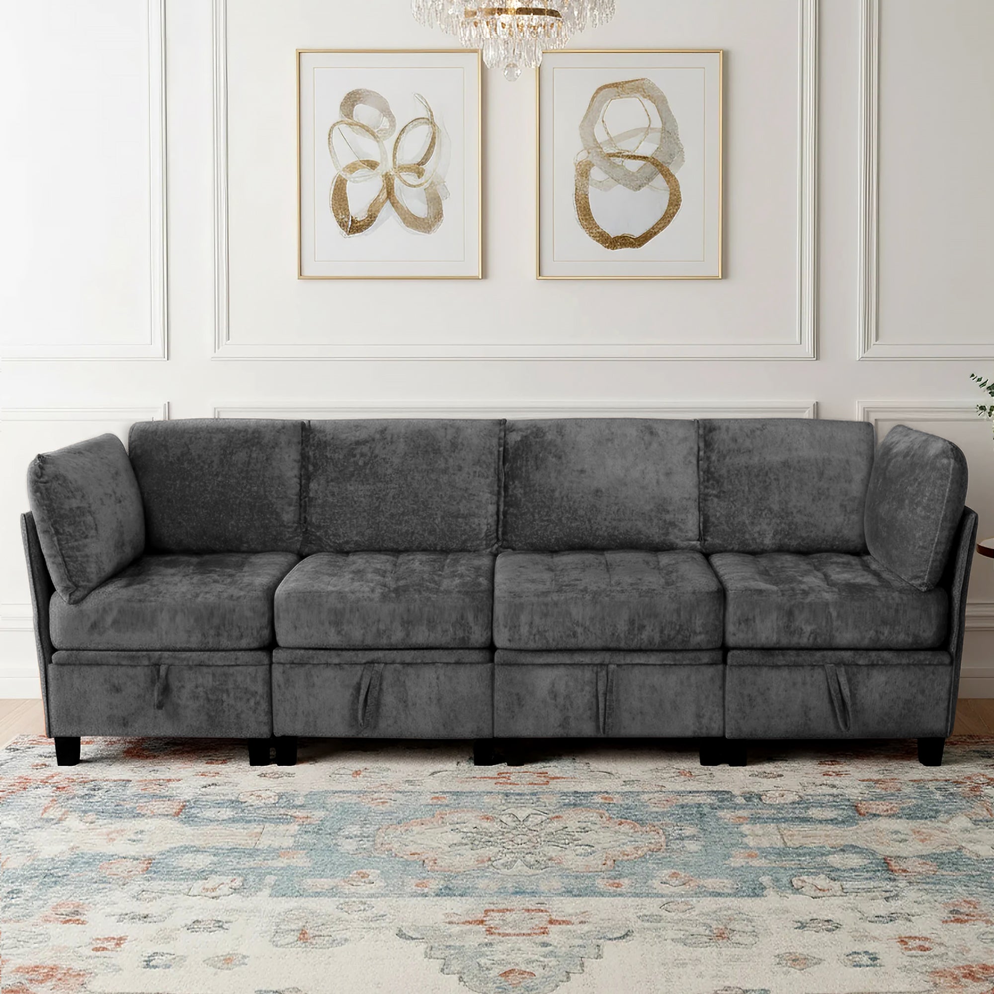 Gray sectional sofa in a room with decorative wall art and a patterned rug.