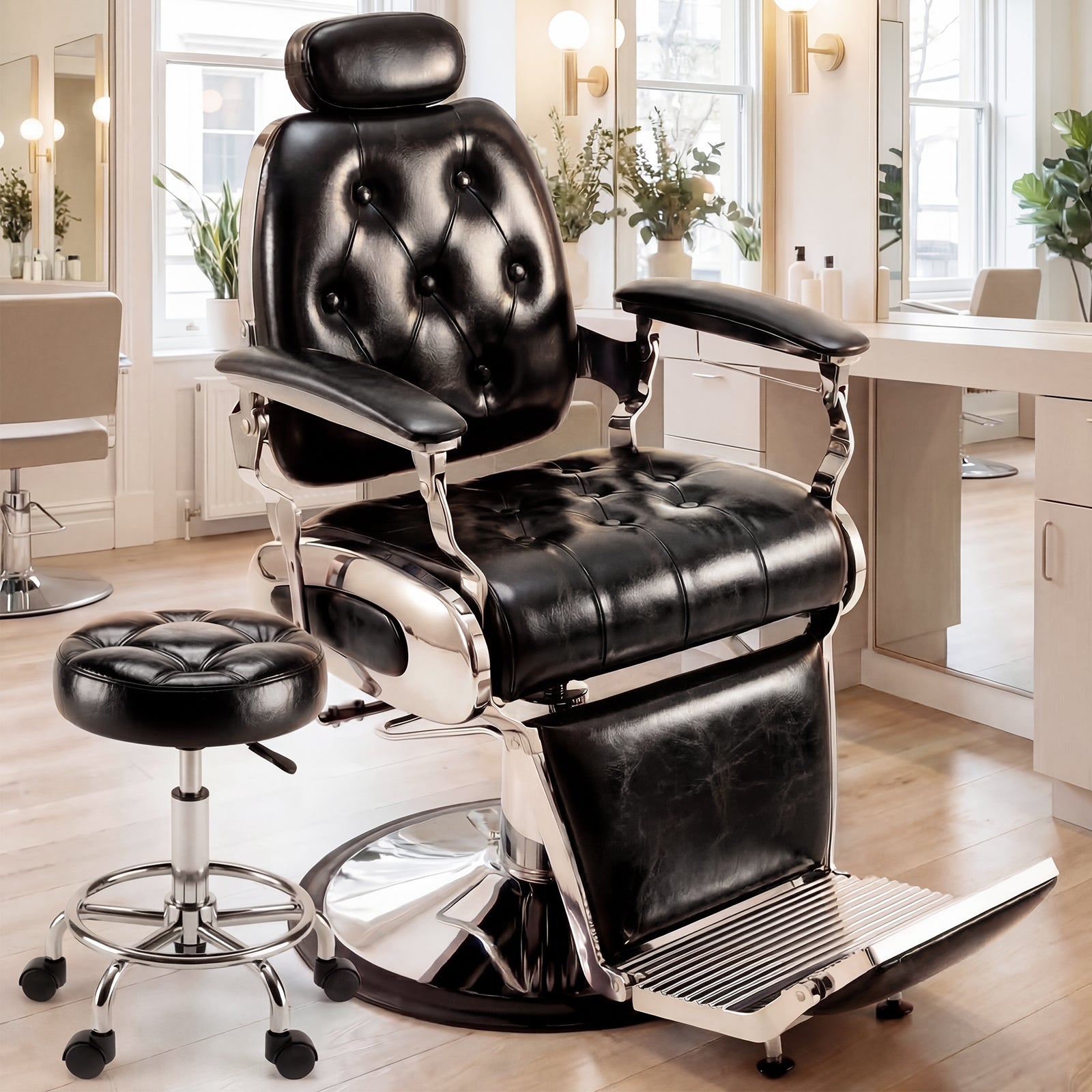 Black leather barber chair in a salon setting with a stool.