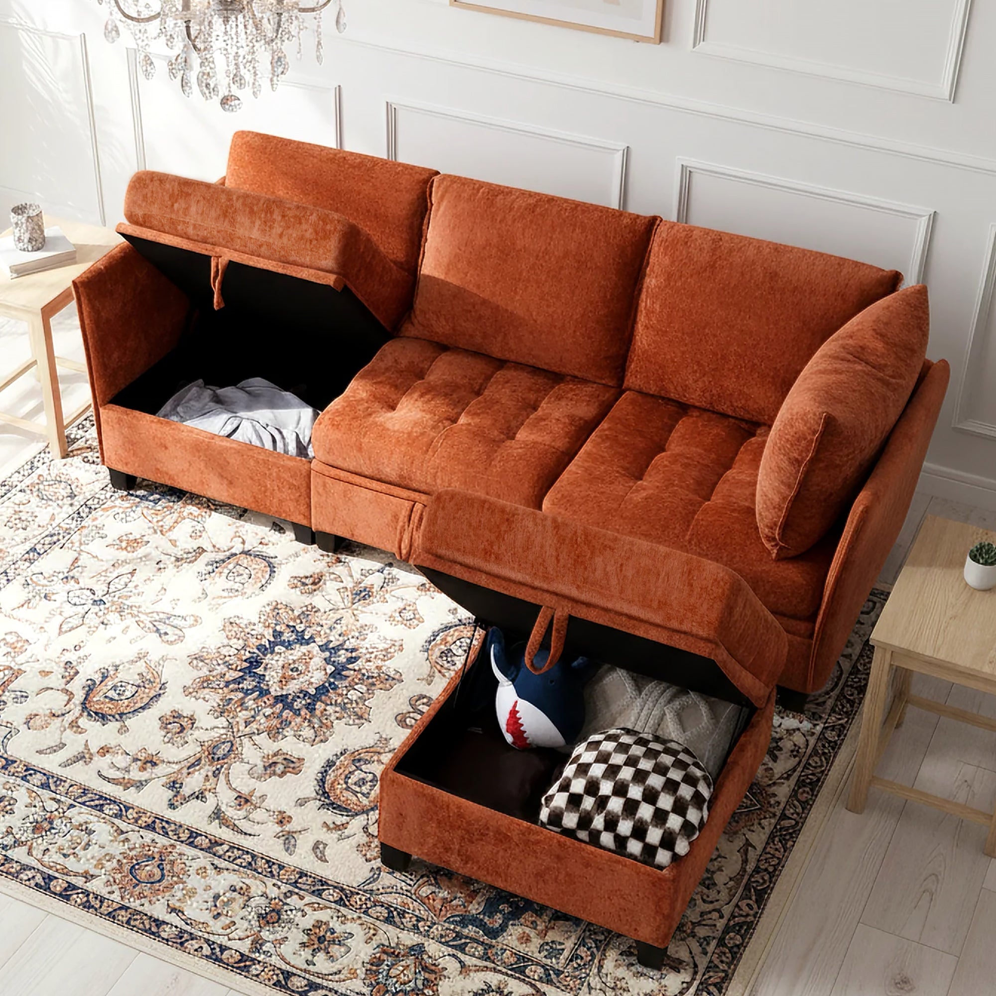 Orange sectional sofa with storage drawers in a living room setting.