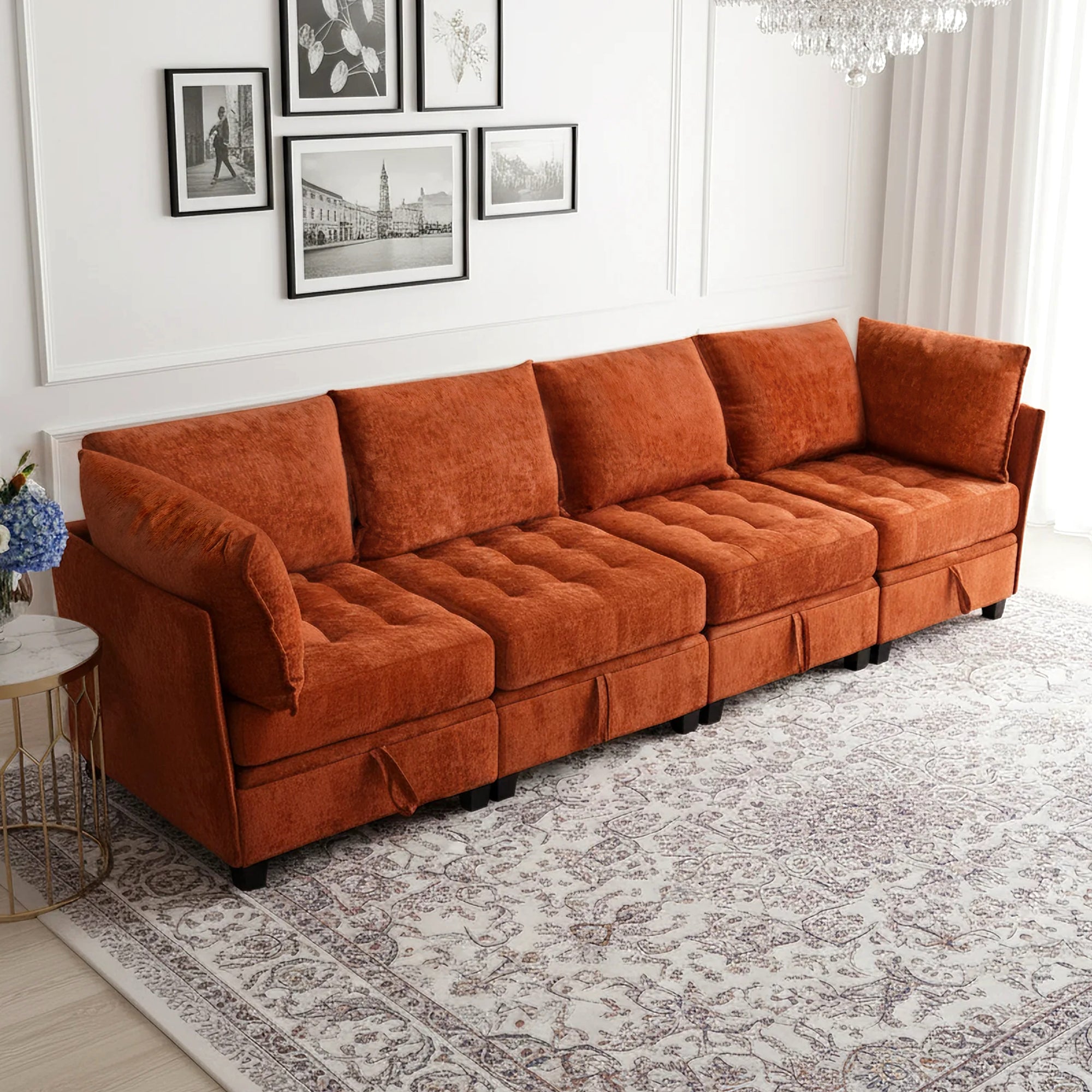 Orange sectional sofa in a living room with framed pictures on the wall.