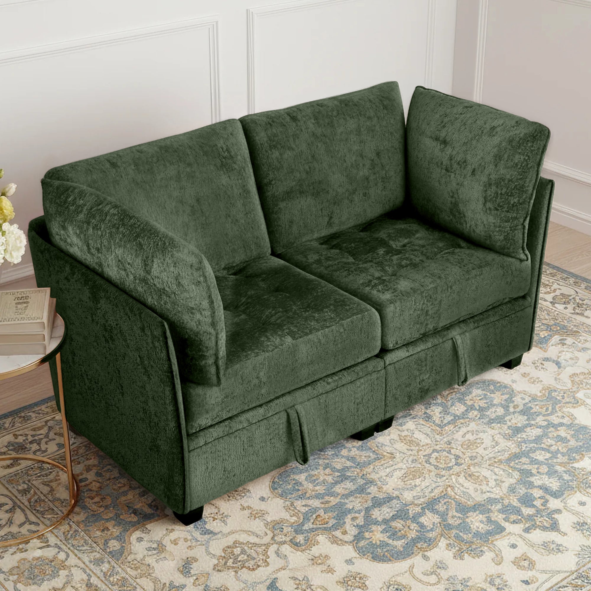 Green sofa in a room with a patterned rug and side table.
