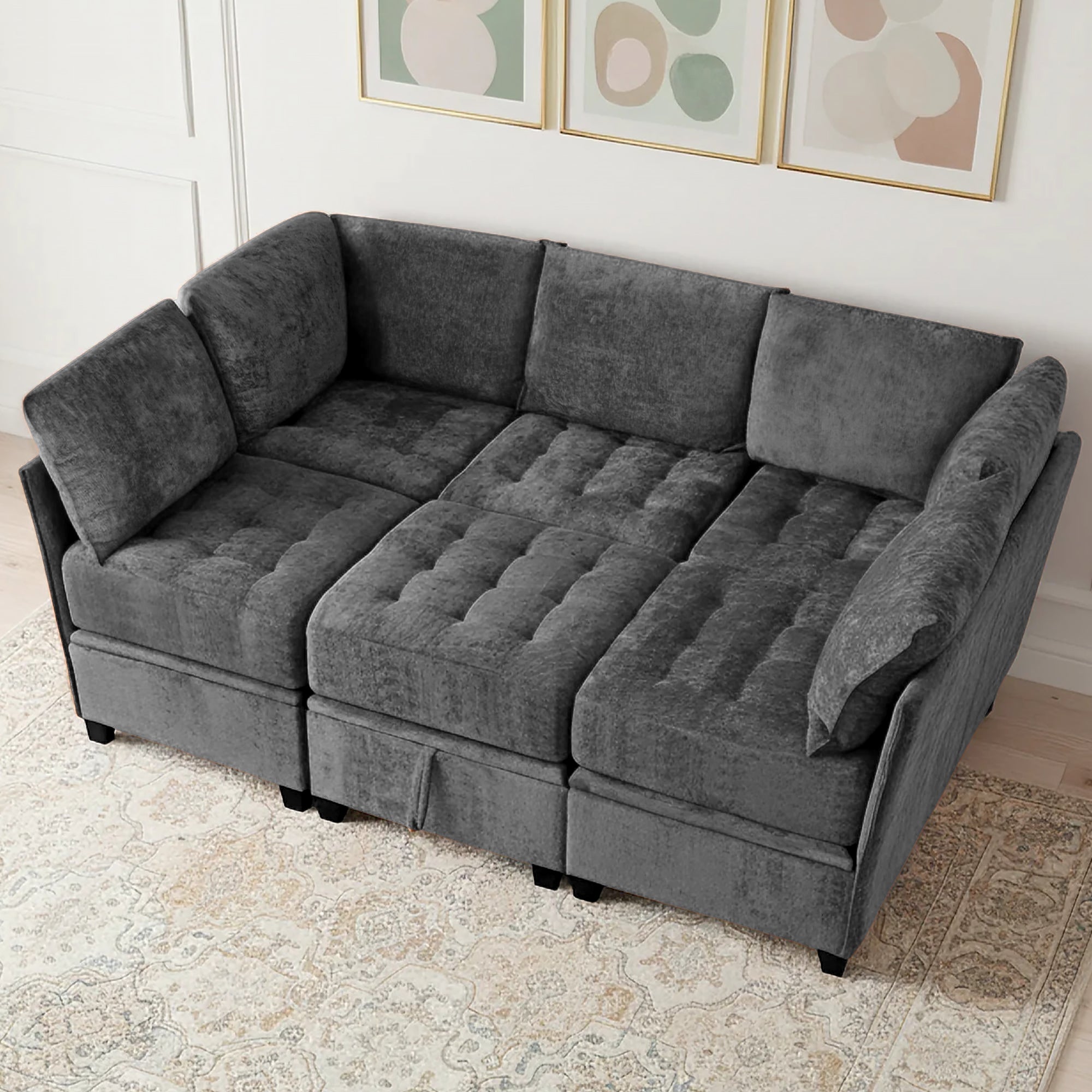 Gray sectional sofa in a living room setting with decorative wall art.