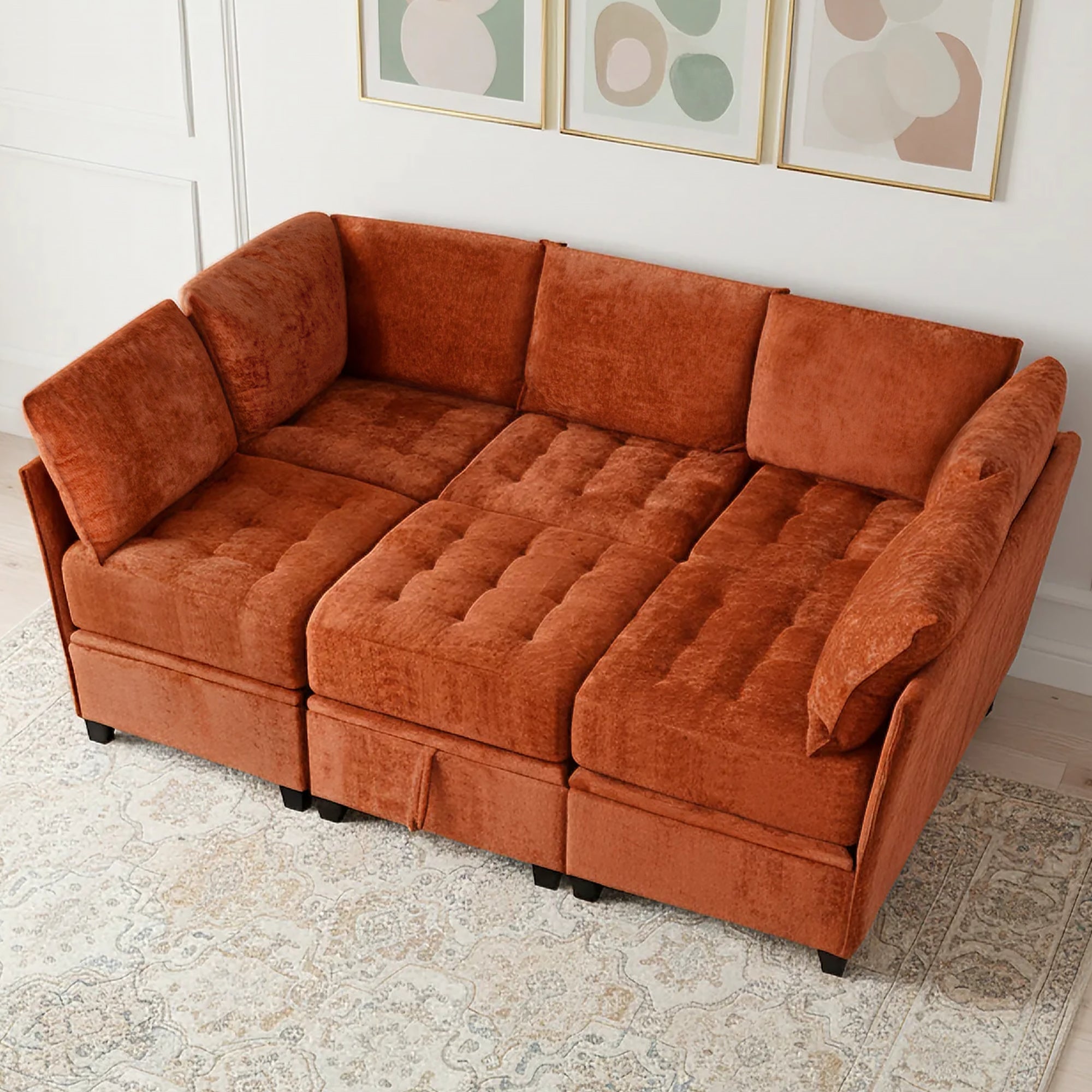 Orange sectional sofa in a room with abstract art on the wall.