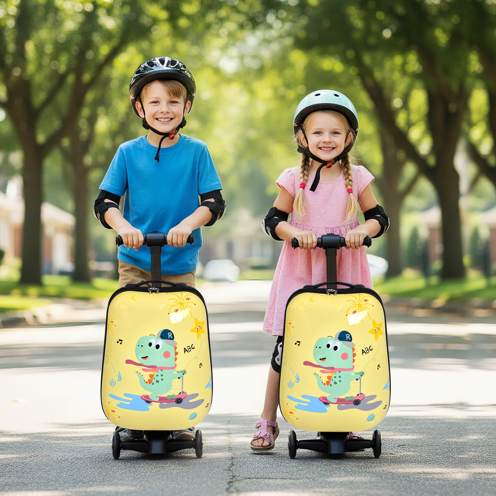 Two children with yellow cartoon-laden suitcases on wheels in a park setting.