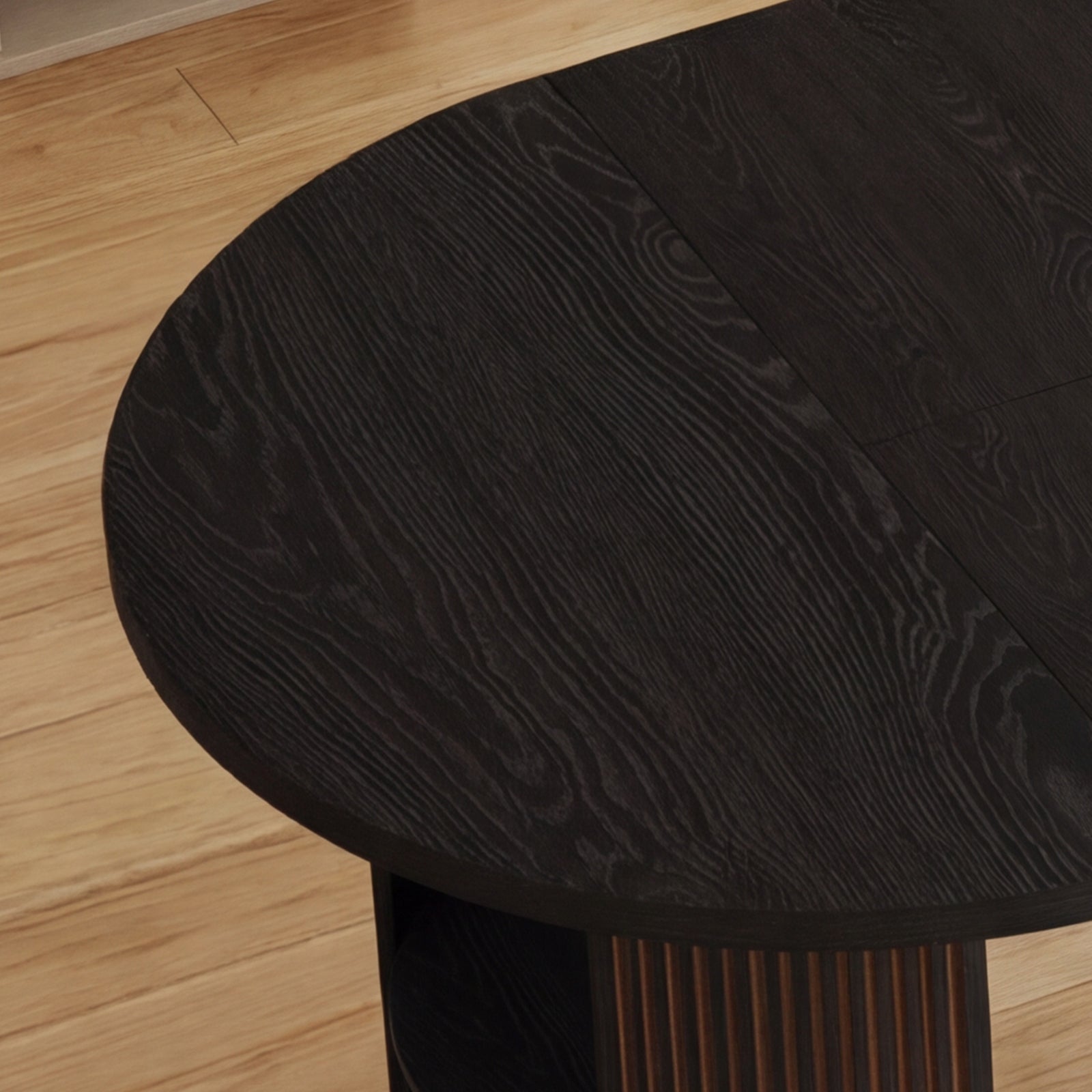 Close-up of a dark wooden stool on a light wood floor