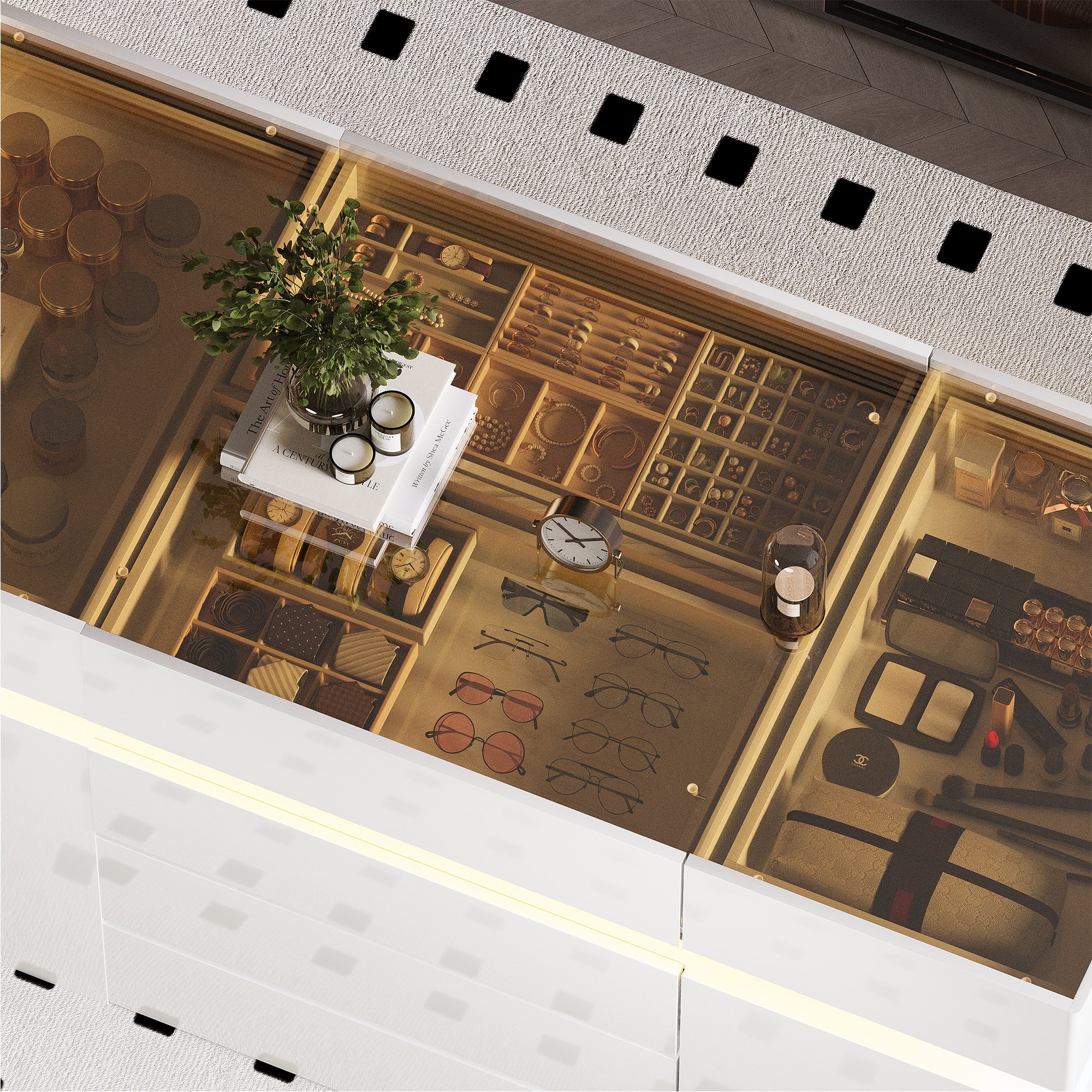 Open jewelry box with various items including watches, glasses, and a plant on a white surface.