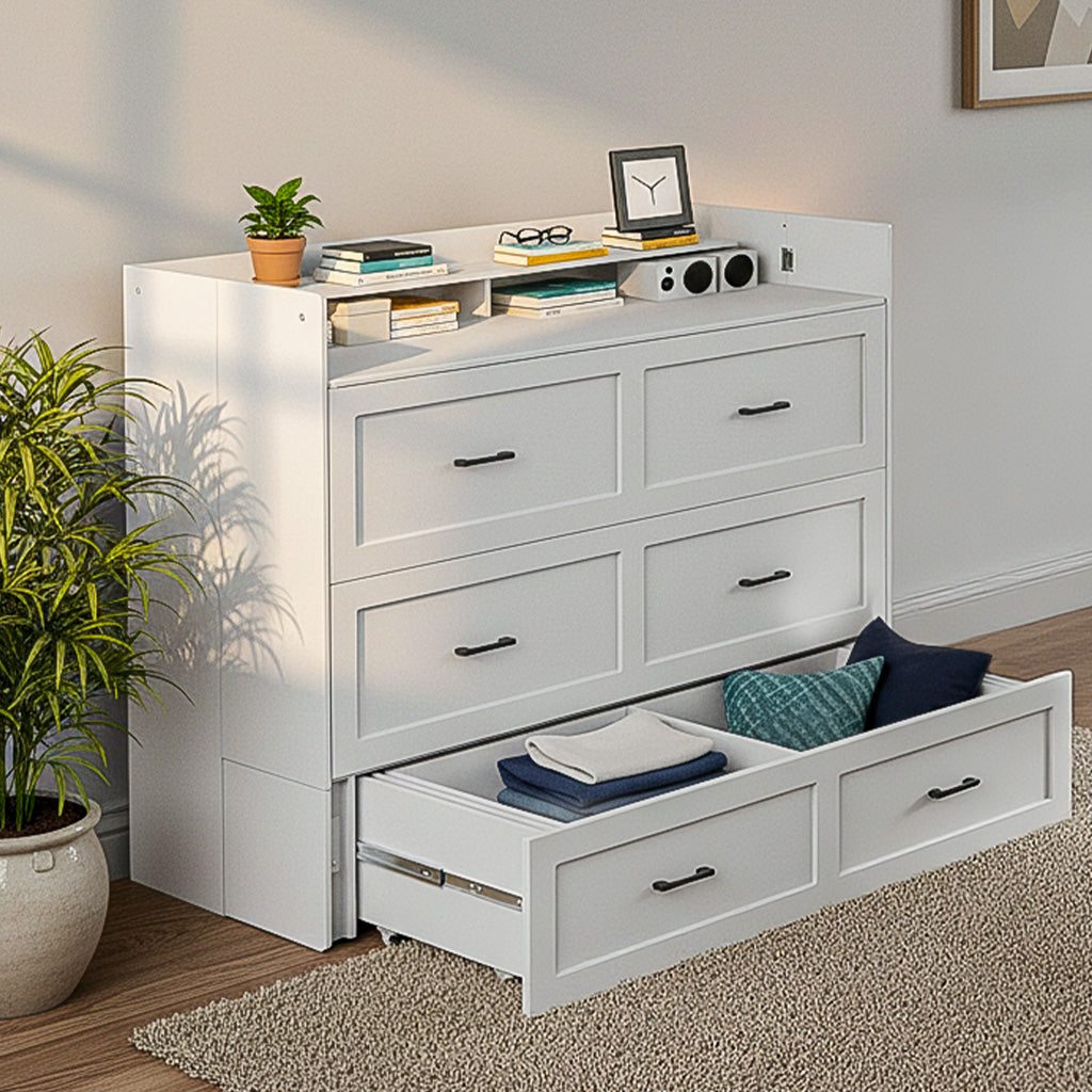 White dresser with open drawer containing folded clothes, books, and decorative items in a room setting.