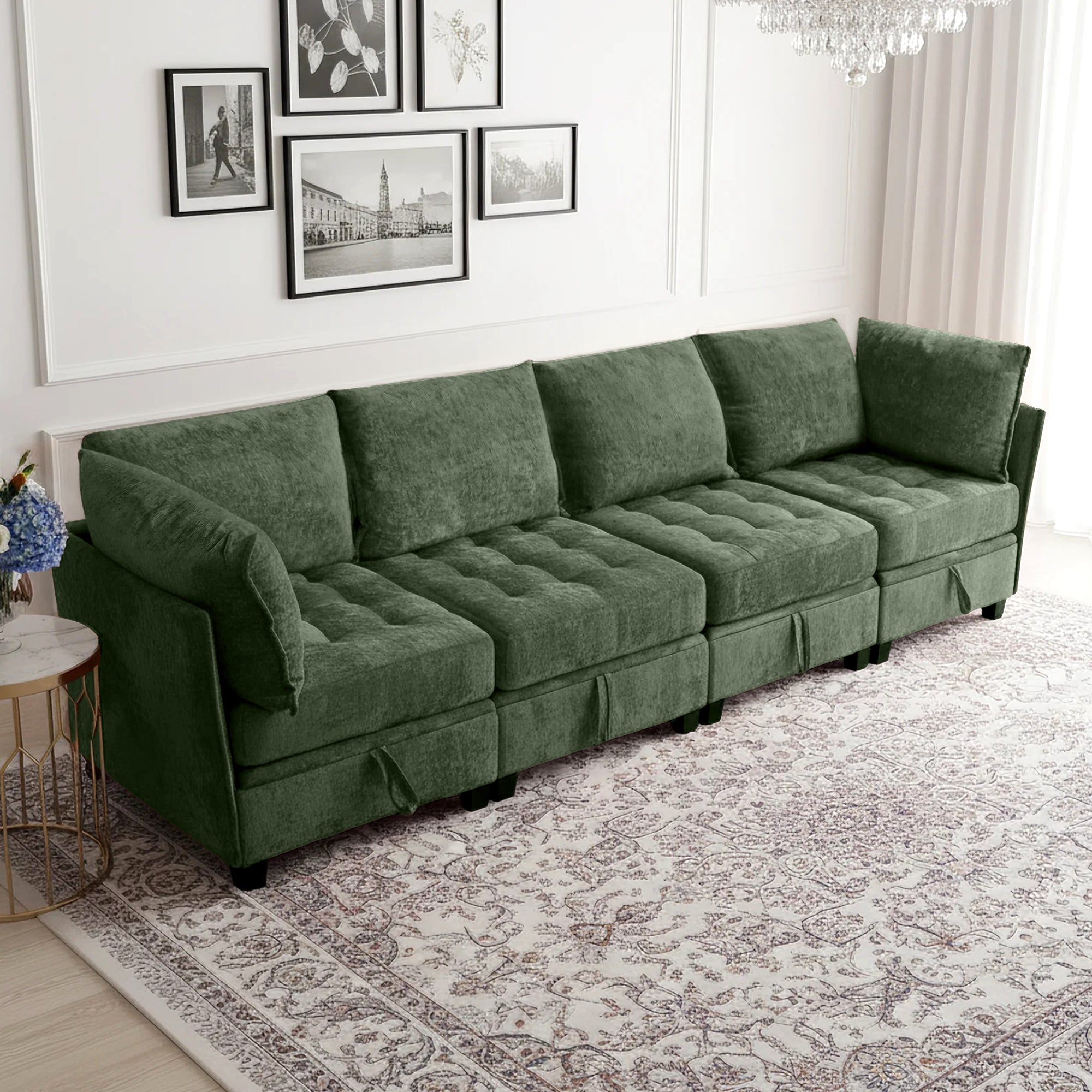 Green sectional sofa in a living room with framed pictures on the wall.
