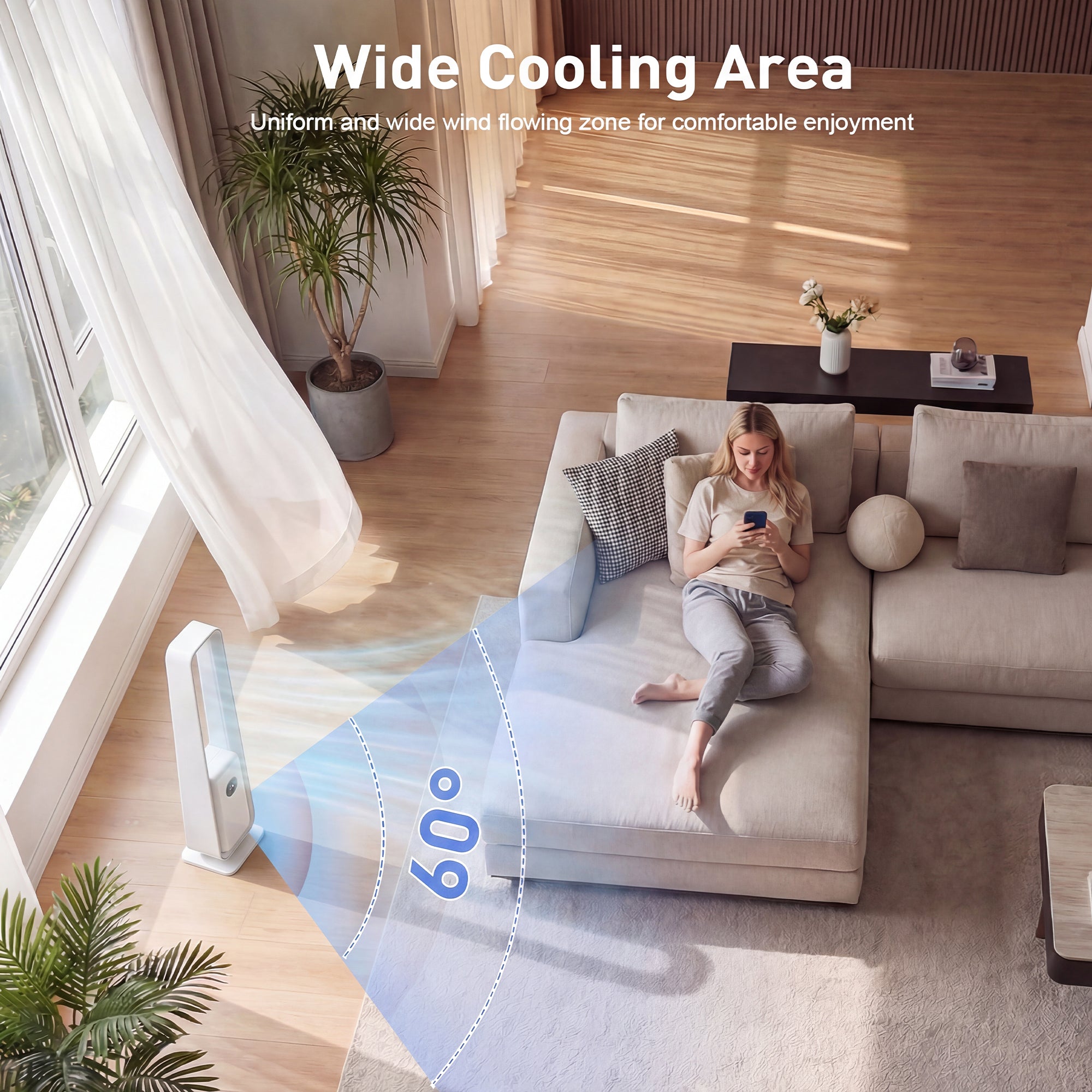 Woman sitting on a couch using a smartphone with a wide cooling area fan in the foreground.