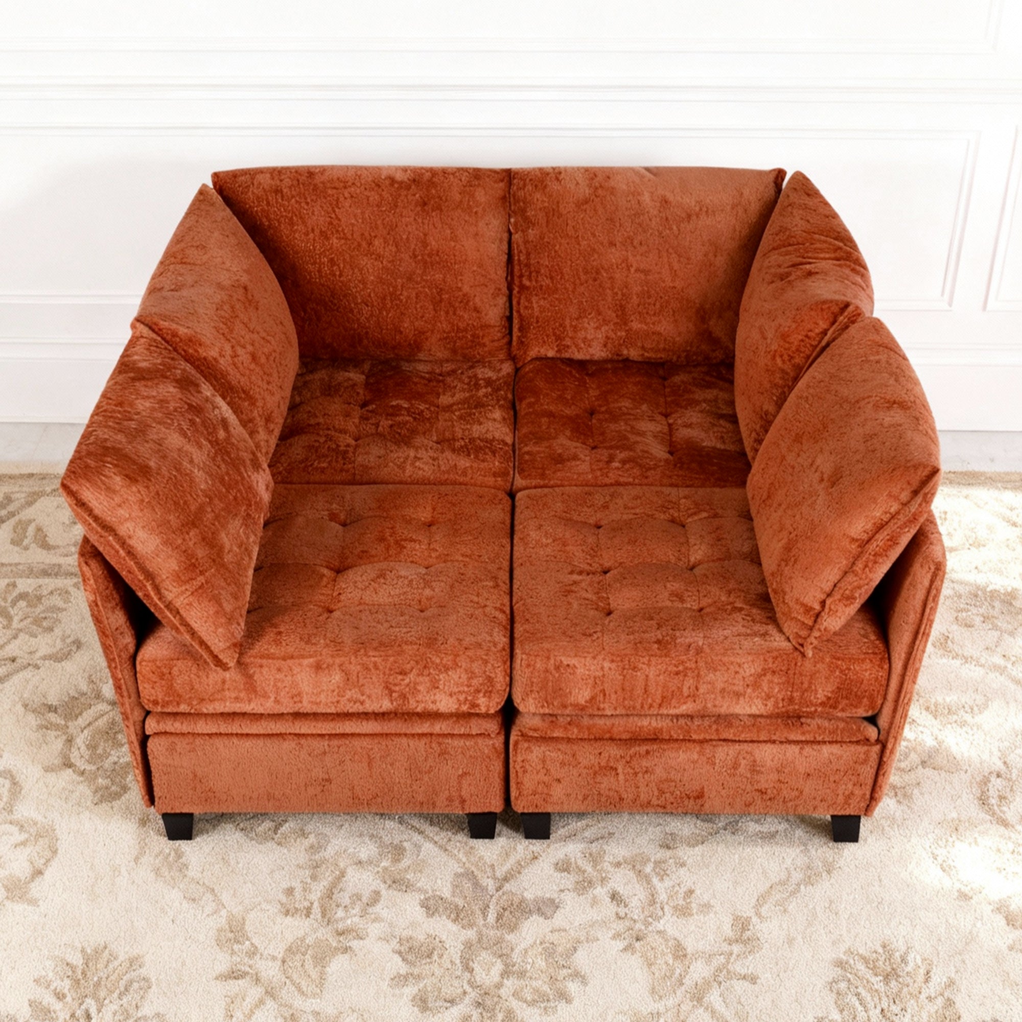 Brown sofa on a patterned rug with a white wall background