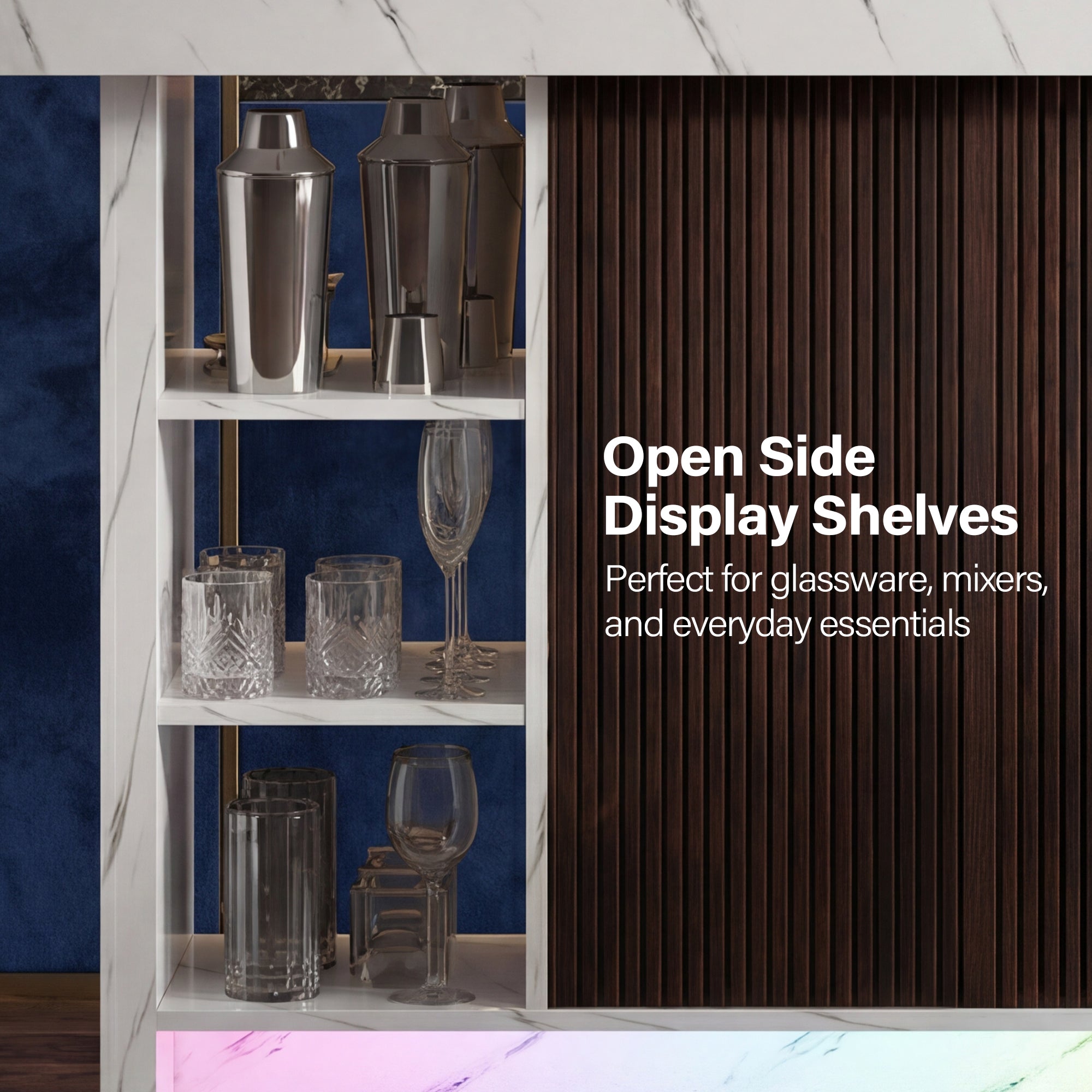Open side display shelves with glassware and mixers against a blue wall.
