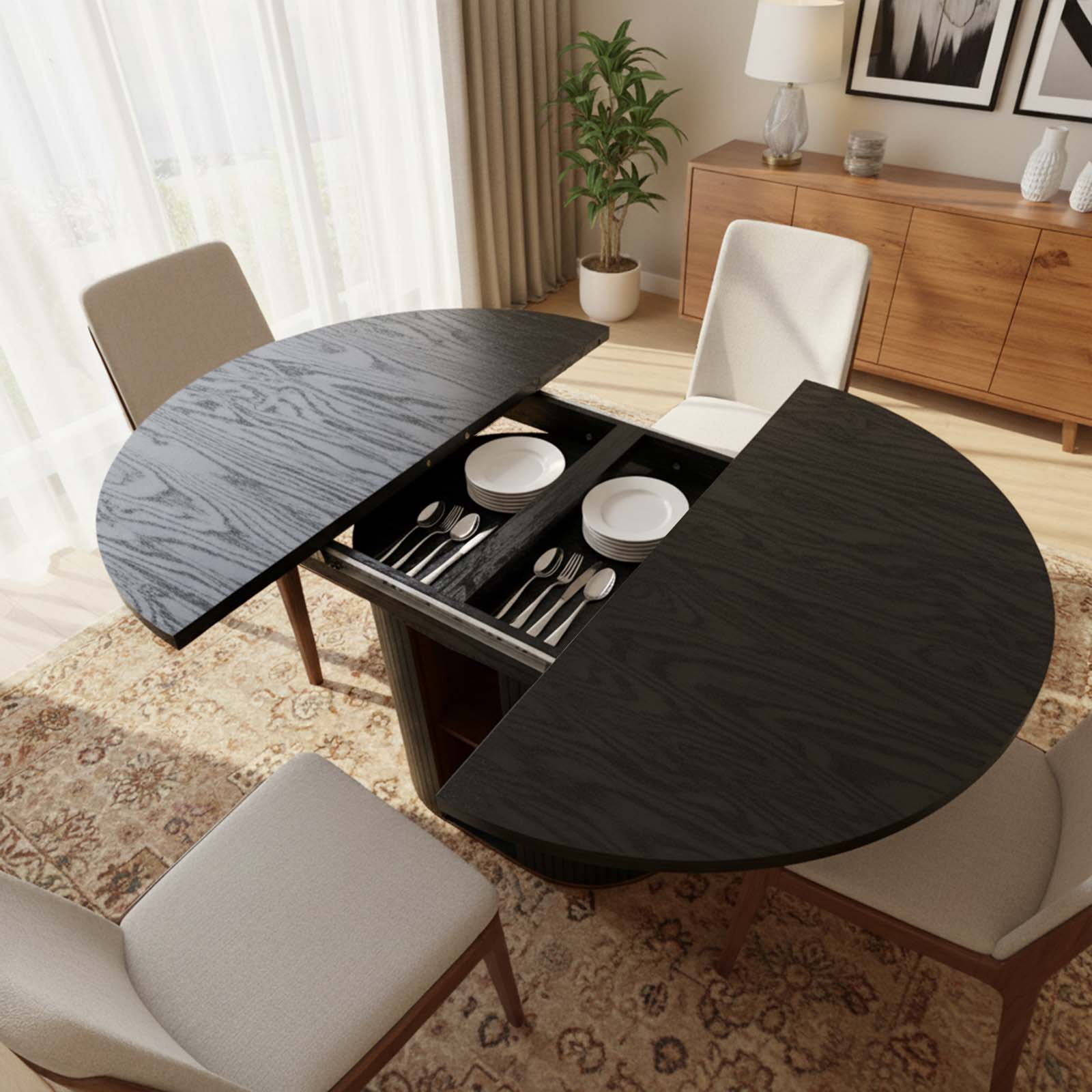 Round dining table with extended leaf in a living room setting